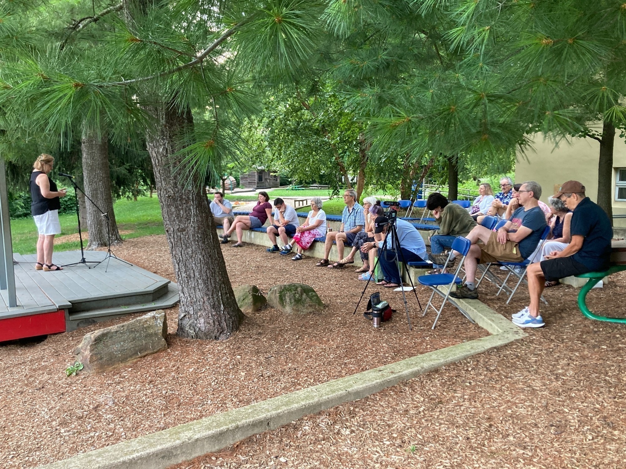 At the Midsummer Night Open Mic event on August 12, there was poetry, music, singing, dance, skits, and bubble wand demonstrations. Here, Bev Benson is speaking to the audience, which included performers and audience from our Meeting and Radnor and Old Haverford Meetings. 