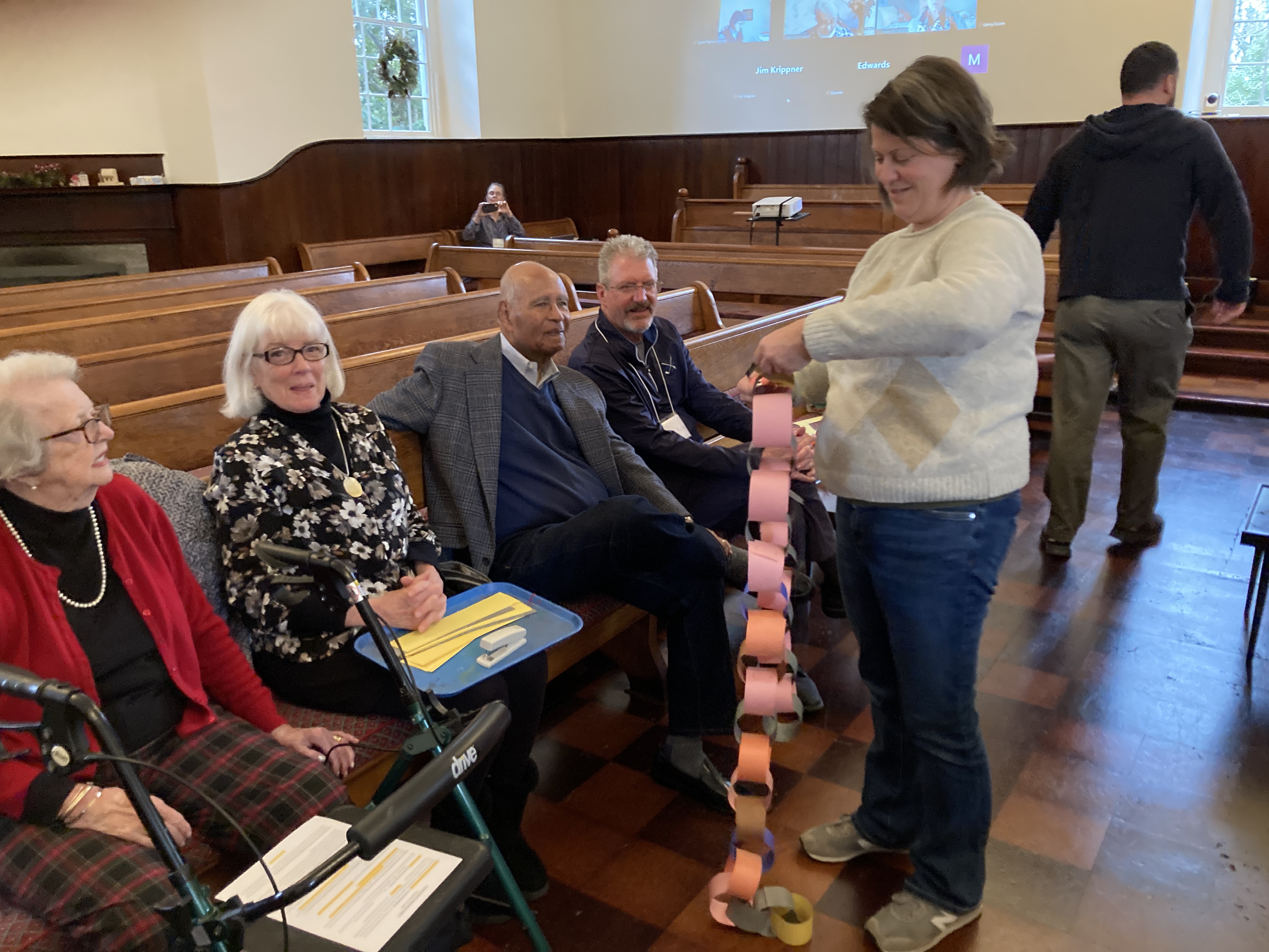 Photo of people making paper chains for the Christmas tree